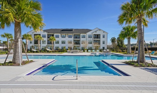 The essence of exceptional living a swimming pool with palm trees and a building in the background
